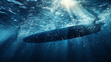 Naklejka premium A mesmerizing underwater view of a surfboard surrounded by bubbles, with sunlight filtering through the ocean water.