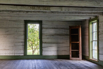 Old abandon log cabin with forgotten shelves or cabinets.