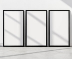 Three empty black frames arranged in a row, casting shadows on a light gray background.