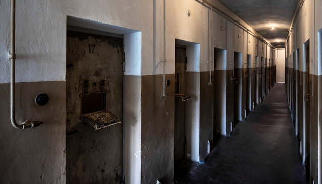 Detention cells next to the main entrance (bunker) at concentration camp Buchenwald. Focus on the door on the left. Weimar, Germany, July 23 2024