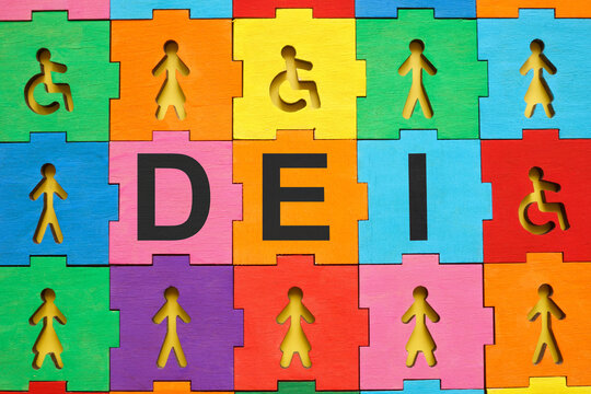 Multicolored puzzle with figures and abbreviation DEI diversity, equity and inclusion.
