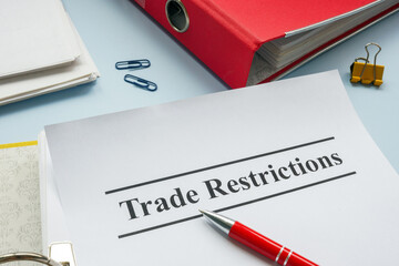 Open folder with document trade restrictions for sanctions.
