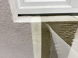 A detailed close up view of a window being meticulously installed into a wall, highlighting the...