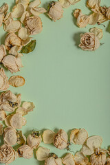 Mock up. Natural frame made by dried withered roses and leaves. Empty space for text