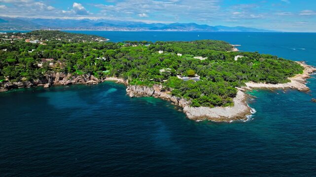 View from above of Billionaire Bay and rocky beach near coastal path on the Cap Antibes. Aerial view of the picturesque bay with luxurious villas, breathtaking views, and crystal-clear waters on Frenc