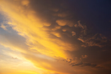 Obraz premium Beautiful sky with unusual red clouds on a sunset. Natural background in orange tones.
