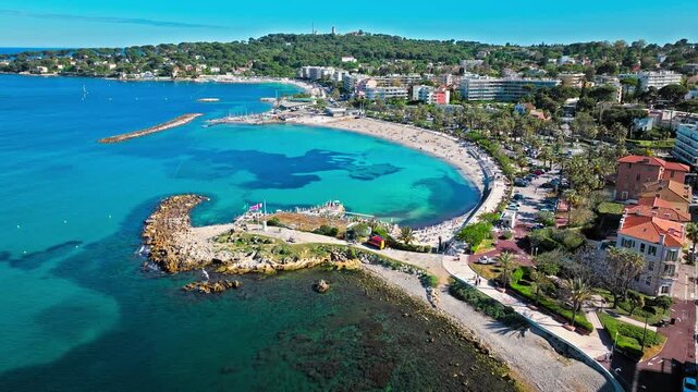 Aerial view of Antibes beach on the French Riviera. People relaxing during summer vacation on a beach with turquoise water in France.