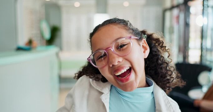 Child, girl and happy with glasses for eye care in store with laughing, excited or blowing kiss for prescription lens. Optometry, kid or portrait with eyewear, spectacles and new frame for healthcare