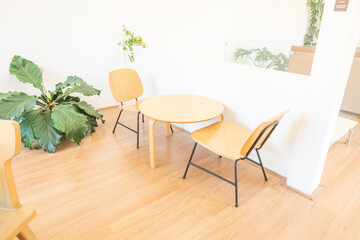 Empty wooden chairs and table in dining room,tropical plants and elegant personal accessories in stylish home decor,Template..