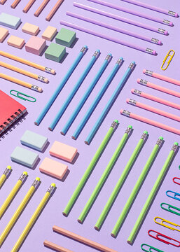 Colorful back to school supplies arranged on purple background