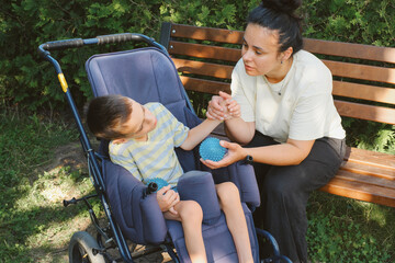 Mother and son with cerebral palsy enjoying time outdoors