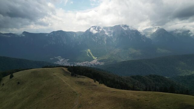 Flying over Baiului Mountains with view on Bucegi mountains. 