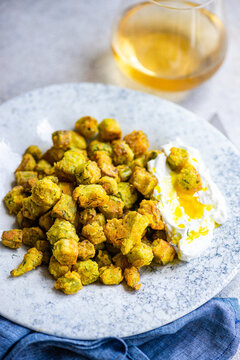 Fried bamia with sour cream sauce on a plate
