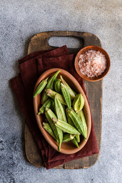 Fresh okra in a rustic setting, ready for Mediterranean cooking
