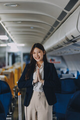 Asian young women passenger walk in airport terminal to boarding gate. Attractive beautiful female tourist friends feeling happy and excited to go travel abroad by airplane for holiday vacation trip.