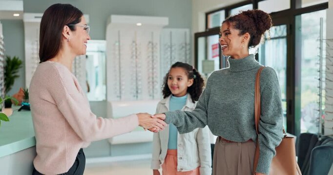 Female people, handshake and specialist with child at ophthalmology center for greeting, welcome or help. Women, optometry and girl for eye care, optometrist and medical professional for consultation