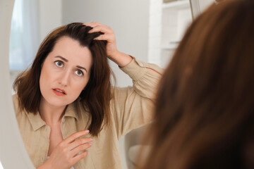 Woman with hair loss problem at home