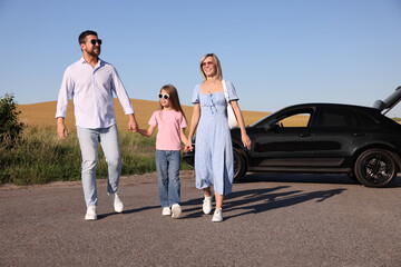 Parents, their daughter and car outdoors. Family traveling