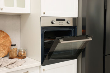 Fototapeta premium Open electric oven in kitchen. Cooking appliance