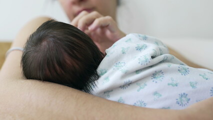 Intimate close-up of a mother nursing and bonding with her newborn baby in her arms during the crucial first days of life. mom caressing infant white breastfeeding