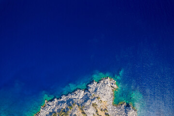 A secluded island in the Aegean Sea reveals crystal-clear water and stunning underwater rock...