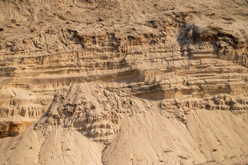 patterns in sand cliff representing coastal erosion