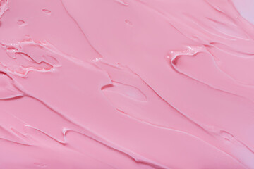 Background swatch texture of pink cream cray, or lipstick cosmetics for face and body . Drop smear...