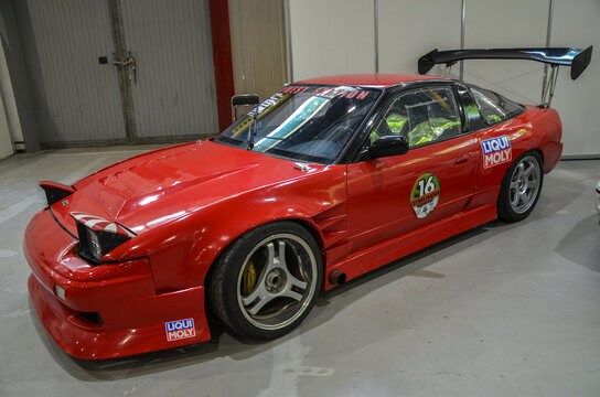 The 1990 Nissan 200SX S13 is a red sporty coupe with long, sweeping lines and pop-up headlights holds a special place in the hearts of car enthusiasts even today