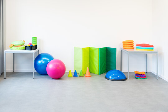 Colorful equipment used in child physical therapy sessions. Physiotherapy room filled with tools.