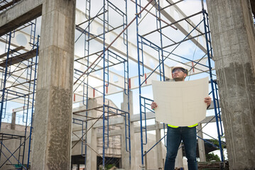 Fototapeta premium Architect is checking the progress of the building project and checking the accuracy of the building structure.