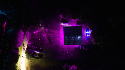 Drone photography of a music festival ar night and concert at stage during summer night