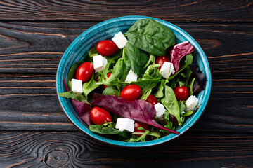 Summer salad with arugula, spinach, cherry tomatoes and cheese feta