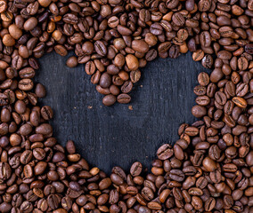 heart shape made from coffee beans on black wooden background, coffee house, coffee lovers