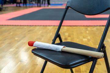 The referee's red and white flags are waiting for the referee on the chairs.