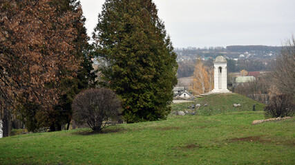 beautiful landscape and a small bell tower. a detail of the building a small bell tower with a cross stands on a hill. faith, religion. space for text. Christianity or Catholicism. autumn time
