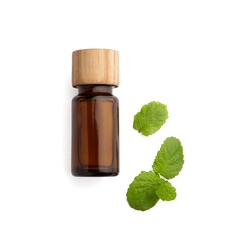 Bottle of essential oil and mint isolated on white, top view