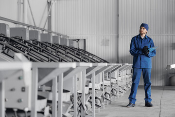 Worker man control quality product on automatic conveyor belt for transporting cedar nuts. Concept...