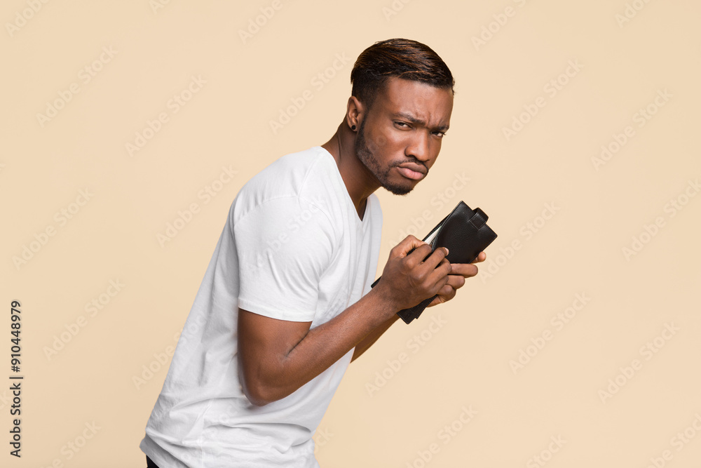 Canvas Prints Theft And Pickpocketing. Sneaky Afro Fraud Man Holding Wallet With Money Standing Over Yellow Studio Background.