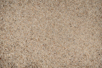 Coarse sand on the seashore, background.