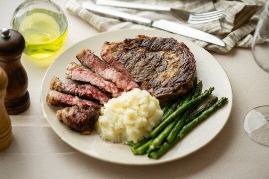ribeye steak with asparagus and mushed potato