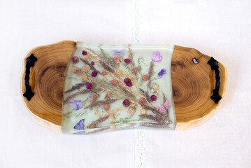 Kitchen board made of wood and epoxy resin. A tray of dried flowers and epoxy. Hand made
