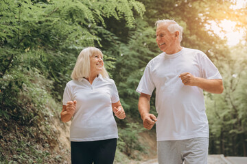 Running, sunshine and senior couple with fitness, exercise and bonding together with challenge. People in park, old man or mature woman with training, retirement and wellness with smile or lens flare