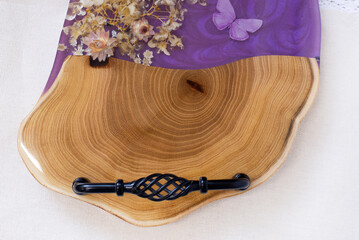 Kitchen board made of wood and epoxy resin. A tray of dried flowers and epoxy. Hand made