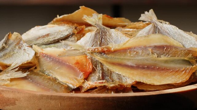 Dry fish snack for beer and drinks yellowstripe scad close-up. The yellowstripe scad is commonly used as a dried fish snack in Asian countries, processed either by salting, curing or mechanical drying