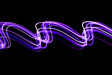 Light Painting Photography - swirly waves of neon purple light against a black background. Long exposure photograph. 