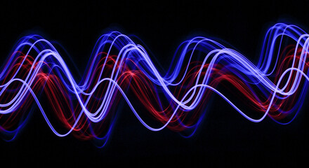 Light Painting Photography - swirly waves of neon light against a black background. Long exposure photograph. 