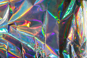 Iridescent foil with colorful holographic background, pink and rainbow foil pattern, shimmering...