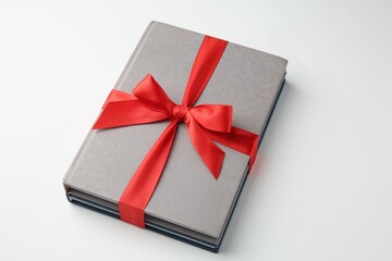 Books tied with red ribbon on white background