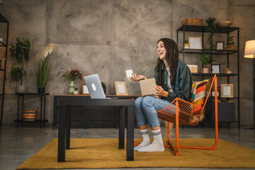 Adult woman read greeting card and talk via video call on laptop