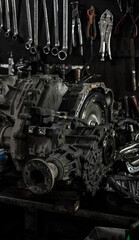 Car repair in a car workshop. Disassembled parts and tools.